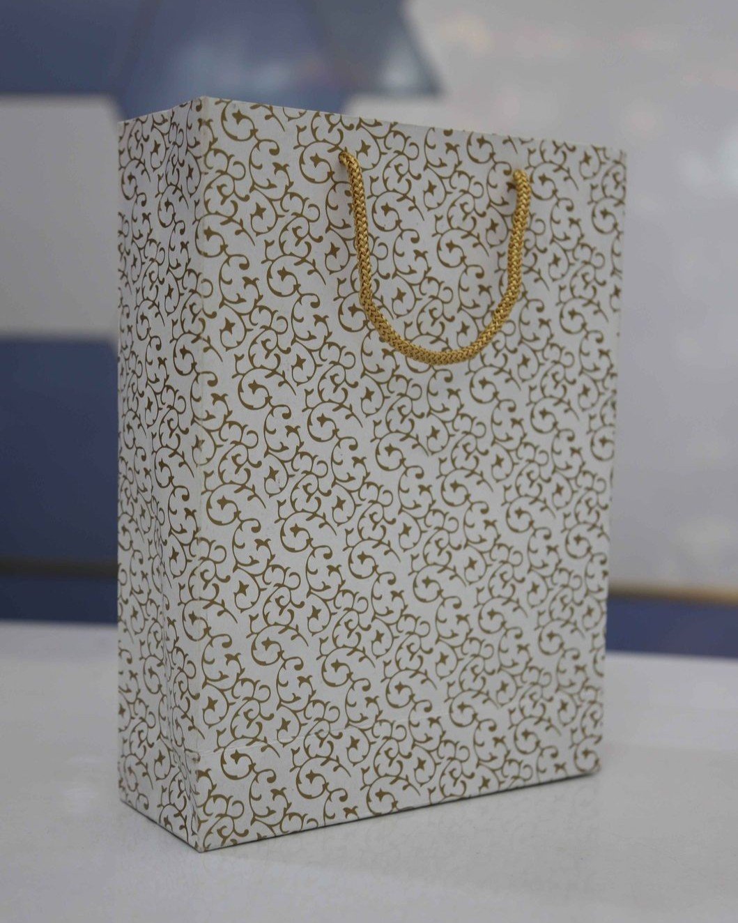 White & gold floral design paper bag