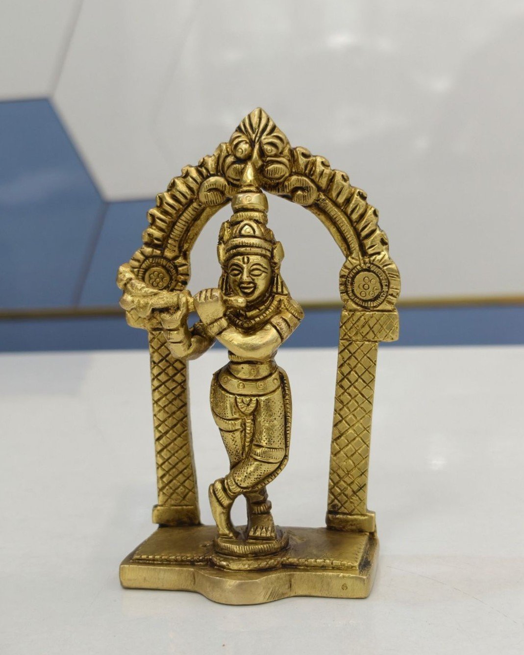 brass krishna idol with arch for puja room