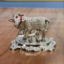 metal Kamadhenu statue with silver idol
